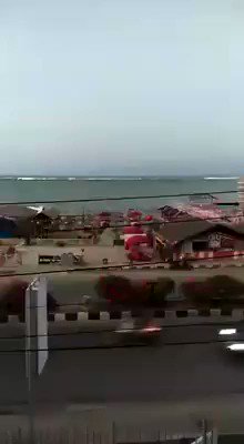 Dramatic video shows a man trying to warn people as a tsunami approaches the Indonesian city of Palu; at least 420 people killed   